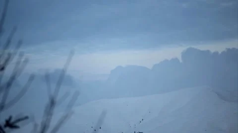 Timelapse of winter moon rise and clouds on snowed mountain peak Stock Footage 10595342