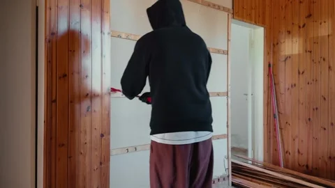 Timelapse of Worker Removing Wooden Wall Paneling With Crowbar During Interior Stock Footage 333788665