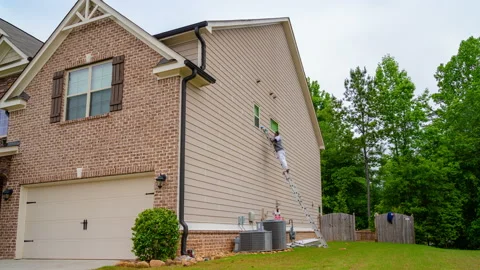 Timelapse of Workers Caulking Side of House Preperation for Painting Stock Footage 147224291