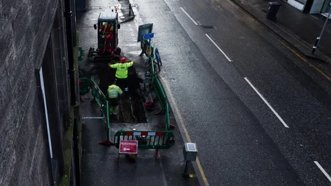 Timelapse of workers digging in an Edinburgh Street from above Stock Footage