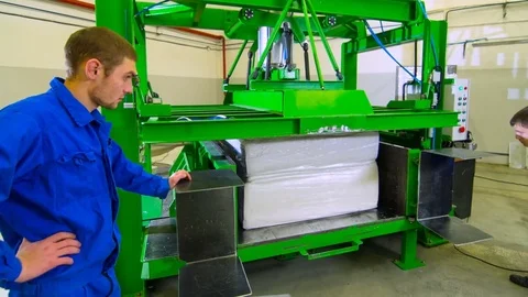 Timelapse Workers Put Large Foam Rubber Cube in Press Machine Stock Footage