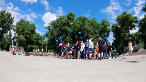 Timelapse of young guys doing tricks on bicycles and scooters at a skatepark Stock Footage 276904245