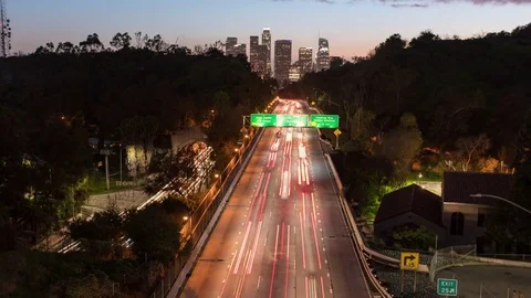 Timelapse zoom in  over the freeway going in to Los Angeles day to night Stock Footage 72637431