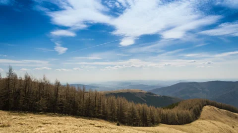 Timelapsed scenery with mountain forest, cloudy sky and valley of cities Stock Footage 37140699
