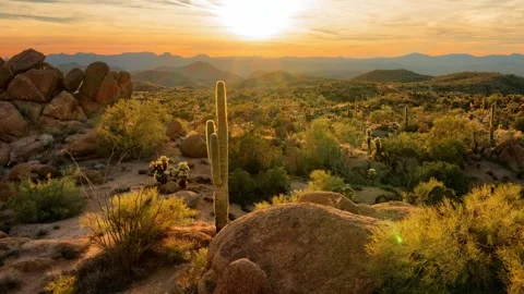 Timelapse/Hyperlapse of a cloudy sunset over a rocky desert valley Stock Footage 304285072