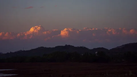 Timelaspe - Cumulus clouds lighting during sunset 4K60 Stock Footage 268794339