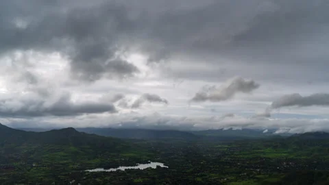 Timelaspe - Monsoon clouds over a lake from a mountain 4K60 Stock Footage 268971405