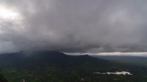 Timelaspe - Monsoon clouds over a valley from a mountain 4K60 Stock Footage 268972608