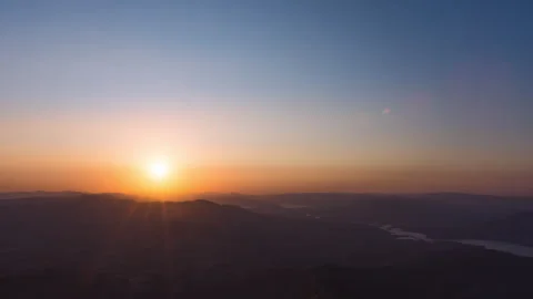 Timelaspe - Sunset behing a mountain range on a clear day 4K60 Stock Footage 271018057