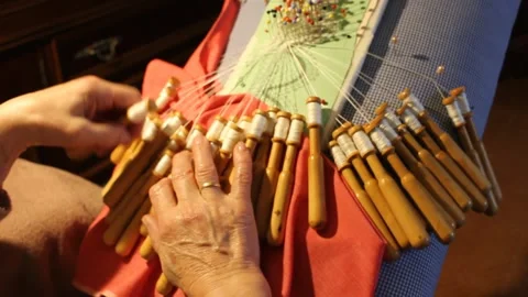 Timeless craft: octogenarian's bobbin lace creations Video stock 258619187