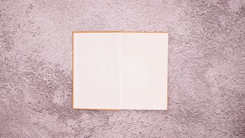 Timeless Elegance: Woman's Hand Unveils the Pages of a Vintage Book Stock Footage 254814382
