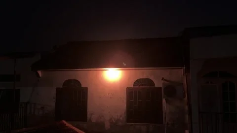 Timeless Night Scene: Rustic Architecture Under The Warm Glow Of An Overhea.. Video stock 325231991
