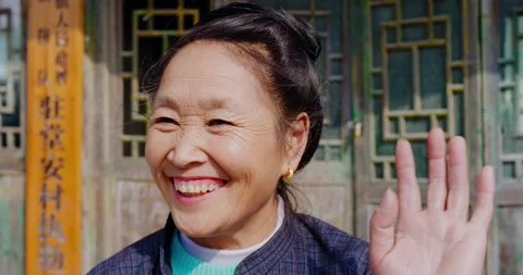 Timeless portrait of a real unique authentic Asian Chinese village woman waving Stock Footage 201094585