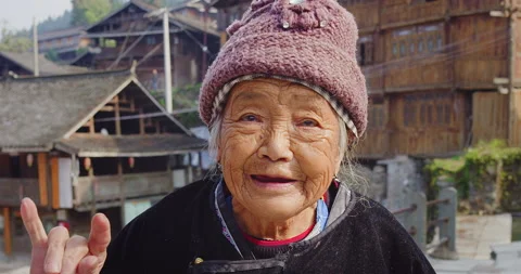 Timeless portrait of a real unique authentic Asian Chinese village woman,  wavin Stock Footage 201096050