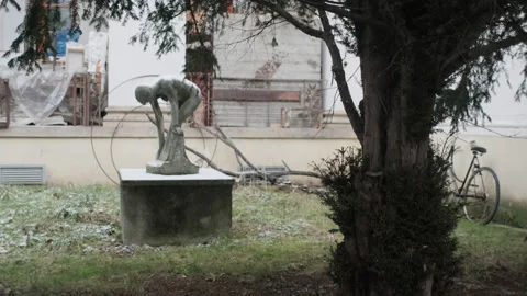 Timelessness scene of a statue in a bohemian backyard with some snow Stock Footage 147926912