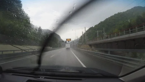 Timelipes view from car moving during rain on new nice road Stock Footage 106591602