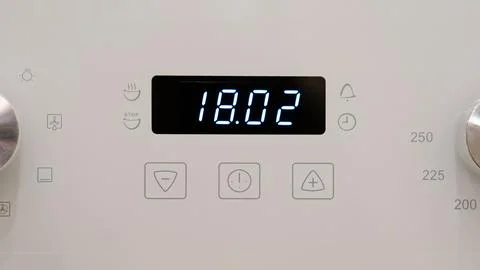 Timer clock on the kitchen oven. Cooking time, close-up Stock Photos
