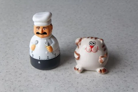Timer in the form of a cook with a cat in the kitchen Stock Photos