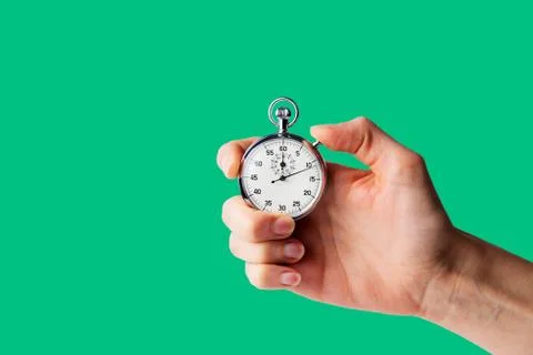 Timer hold in hand, green backround 20a075 Stock Photos
