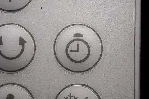 Timer icon and button close up of an air conditioner remote controller Stock Photos