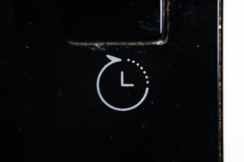 Timer icon on washing machine close up. Old and dirty Stock Photos