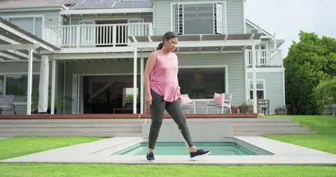 Timer is starting while woman is stepping, lunging, balancing poolside for leg Stock Footage 341851970