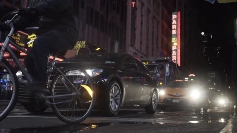 Times Square Bycicle rides by Traffic Slowmo Stock Footage 78682853
