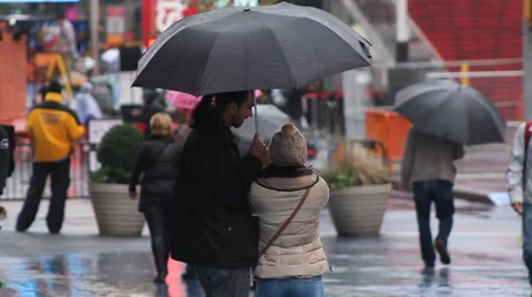 Times Square, fall, man and woman Facetime under umbrella Stock Footage 32965145