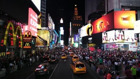 Times Square at night with advertisement screens billboards in NYC New York City Stock Footage