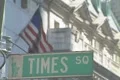 Times Square street sign with an American Flag behind it Footage