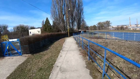 Timewarp Walk On The Bridge Through Park Along The River. Stock Footage 112720624