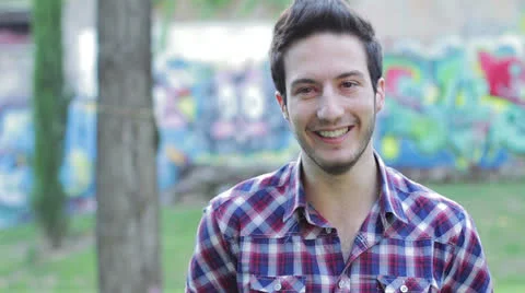 Timid man laughing and looking at the camera Stock Footage 24702156