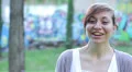 timid woman laughing and looking at the camera HD Footage