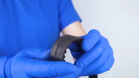 Timing belt cracked. Replacing a failed engine transmission belt. Cracks in rubb Stock Footage 241559878
