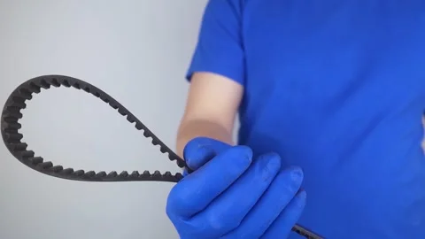 Timing belt cracked. Replacing a failed engine transmission belt. Cracks in rubb Stock Footage 241559896