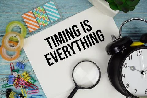 Timing is Everything text on a paper surrounded by office supplies, a magni.. Stock Photos