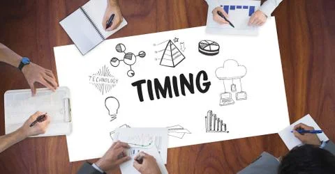 Timing text surrounded by graphics and business people's hands Foto stock