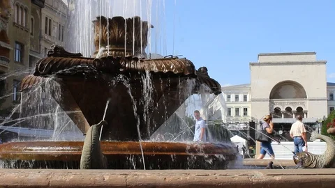 TIMISOARA, ROMANIA - June 28, 2017: A fountain with pigeons and people Stock Footage 97399786