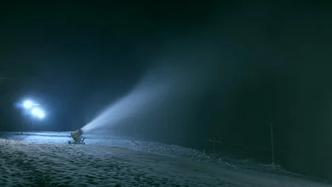 Timlipse of Snow making system. A snow cannon sprays water and makes snow Stock Footage 124277768