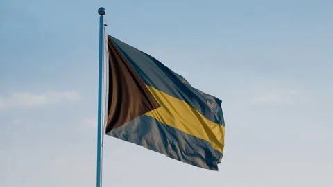 Timor-Leste, Dili: Cinematic Waving National Flag Against Blue Sky Video stock 326439251