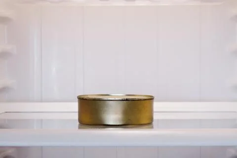 Tin can in empty fridge Stock Photos