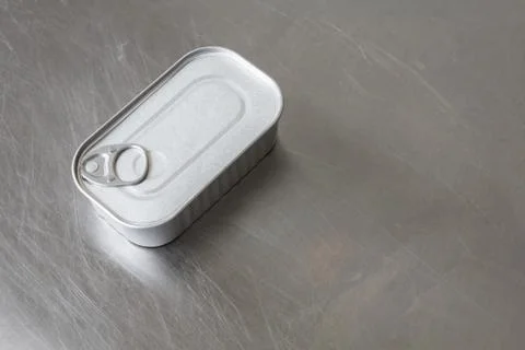 Tin can for fish on shiny table Foto stock