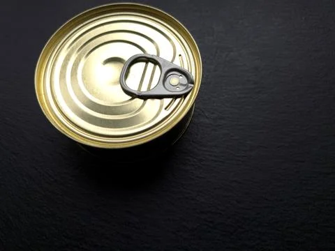 Tin Can With a Key on Dark Surface Ready to Be Opened in Kitchen Setting Du.. Stock Photos
