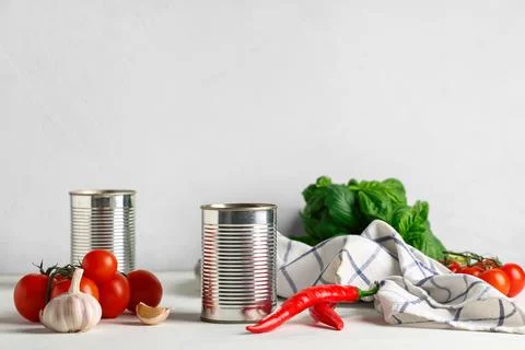 Tin can with tomato paste and ingredients on white table Stock Photos