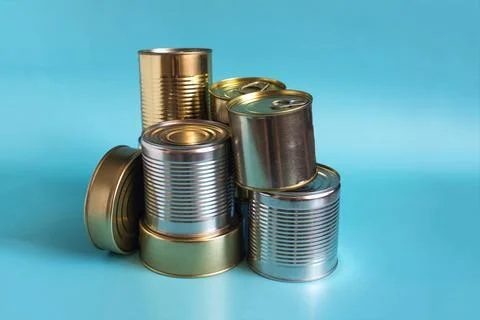 Tin cans in close-up on a colored background. Stock Photos