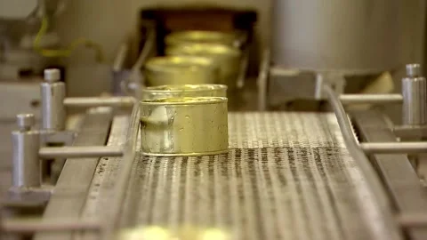 Tin cans of fish fillet approaching the conveyor on the camera Stock Footage 102060862