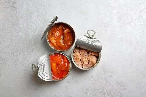 Tin cans with fish on grey table, flat lay 写真素材