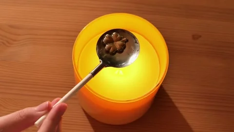 Tin casting set.tin clover figurine in spoon. Fortune telling with melting tin Stock Footage 284751244