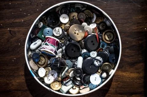 Tin of old buttons Stock Photos