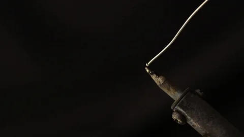Tin soldering iron on a black background Stock Footage 93716085